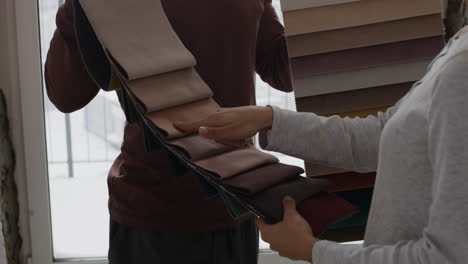couple choosing fabric swatches for interior design