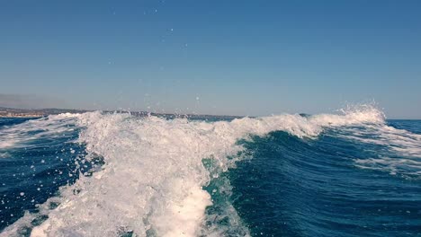 speed boat wake tail trail and water spray on sea surface