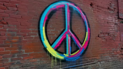 colorful peace sign graffiti on a brick wall
