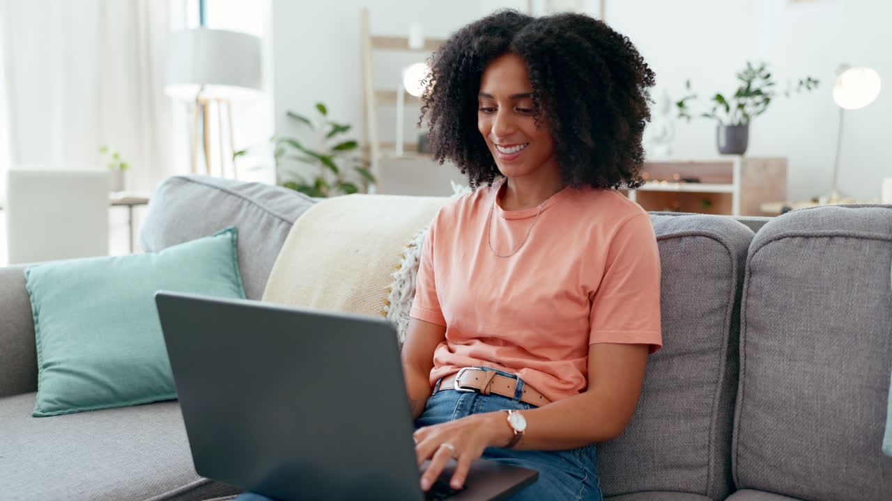 Remote worker, laptop and woman typing on sofa