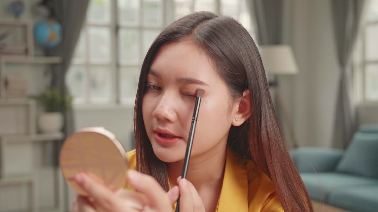 Beauty Blogger With Eye Shadow Brush Talking To Camera, Makeup Tutorial Video At Home Studio