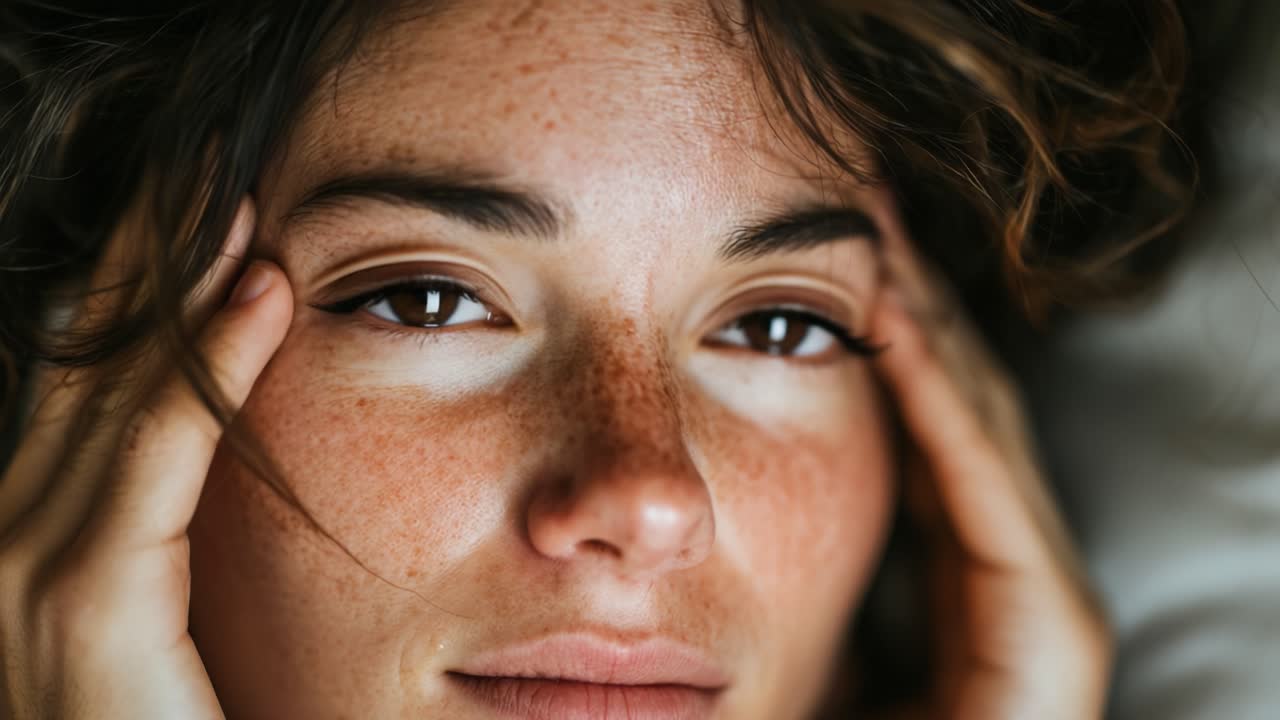 A Serene Moment of Stillness: Close-Up of a Young Woman Savoring Tranquility and Reflecting in a Cozy Environment with Eyes Closed and Thoughtful Expression