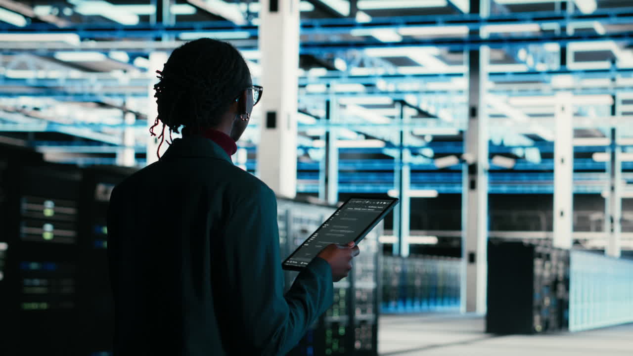 Female IT Engineer Working on Tablet in Data Center