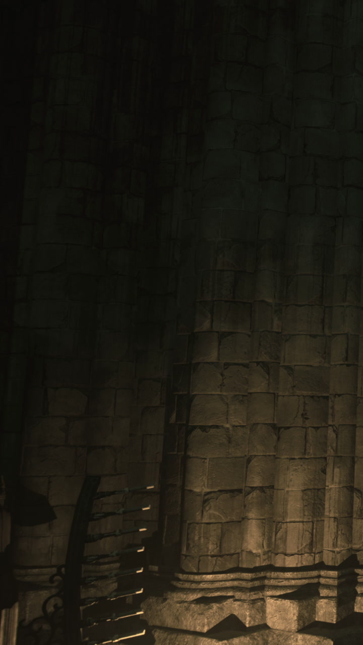 Light and shadows play on a stone wall in a dark old building at night