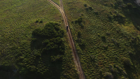 Top-view-Drone-shot-over-quad-bike-driving-on-a-gravel-road-over-a-mountain