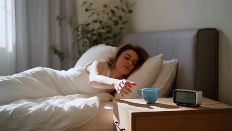 woman waking up in her bed in the morning