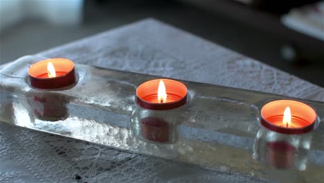 Top-view-of-three-scented-candles-on-a-table-in-the-house