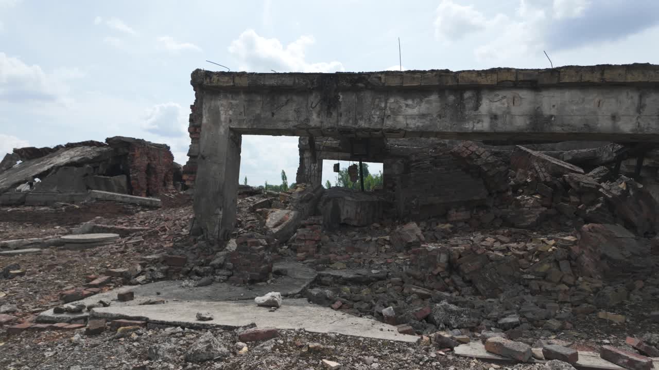Rubble and ruins at Auschwitz Birkenau concentration camp, Poland. The scene reflects the somber history and memorials of World War II. Overcast sky enhances the somber ambiance.