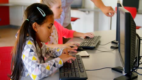 asian female teacher teaching schoolkids on computer in the school 4k
