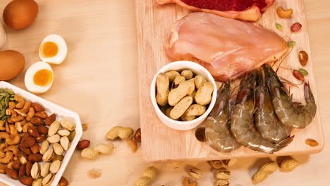 assorted meats, nuts, and eggs on a table