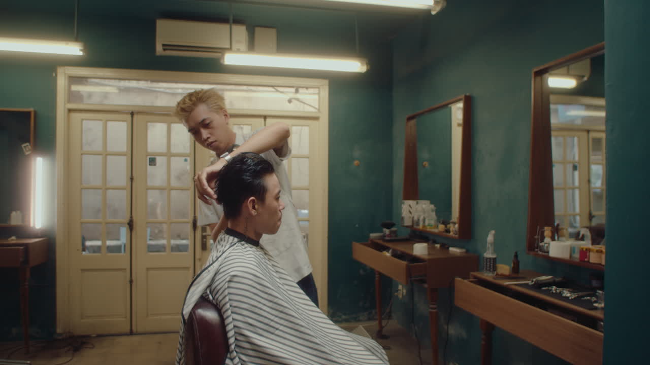 Barber Drying Hair of Male Client after Giving Haircut