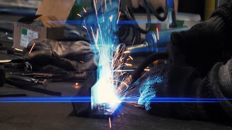 metal welder works with a steel welder in a factory with protective equipment