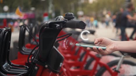 unlocking a bike using a smartphone in a city park