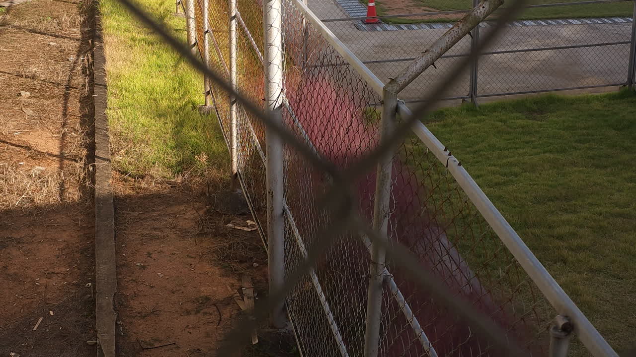 Looking Through Barbed Wire Fence Inside Prison Close-up Prisoner's POV