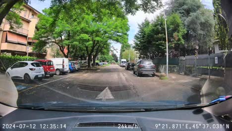front dash cam pov through windshield driving through town sunny day drive