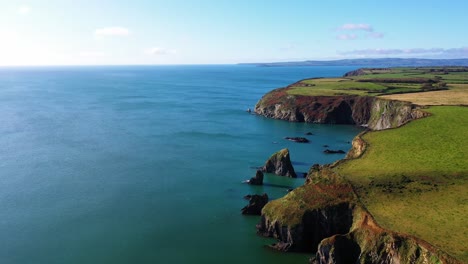 aerial flying over sea near cliffs at at southeast ireland