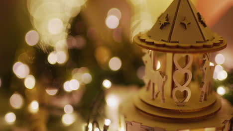 close-up of christmas carousel music box against bokeh lights