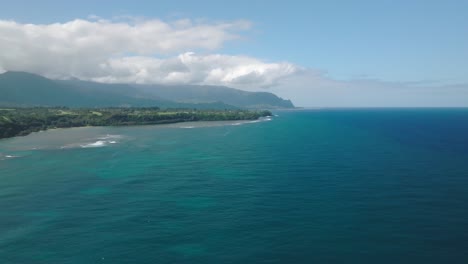 wide aerial shot tracking right of anini beach, kauai, hawaii