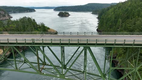 Side-scrolling-drone-shot-of-Deception-State-Park's-steel-bridge