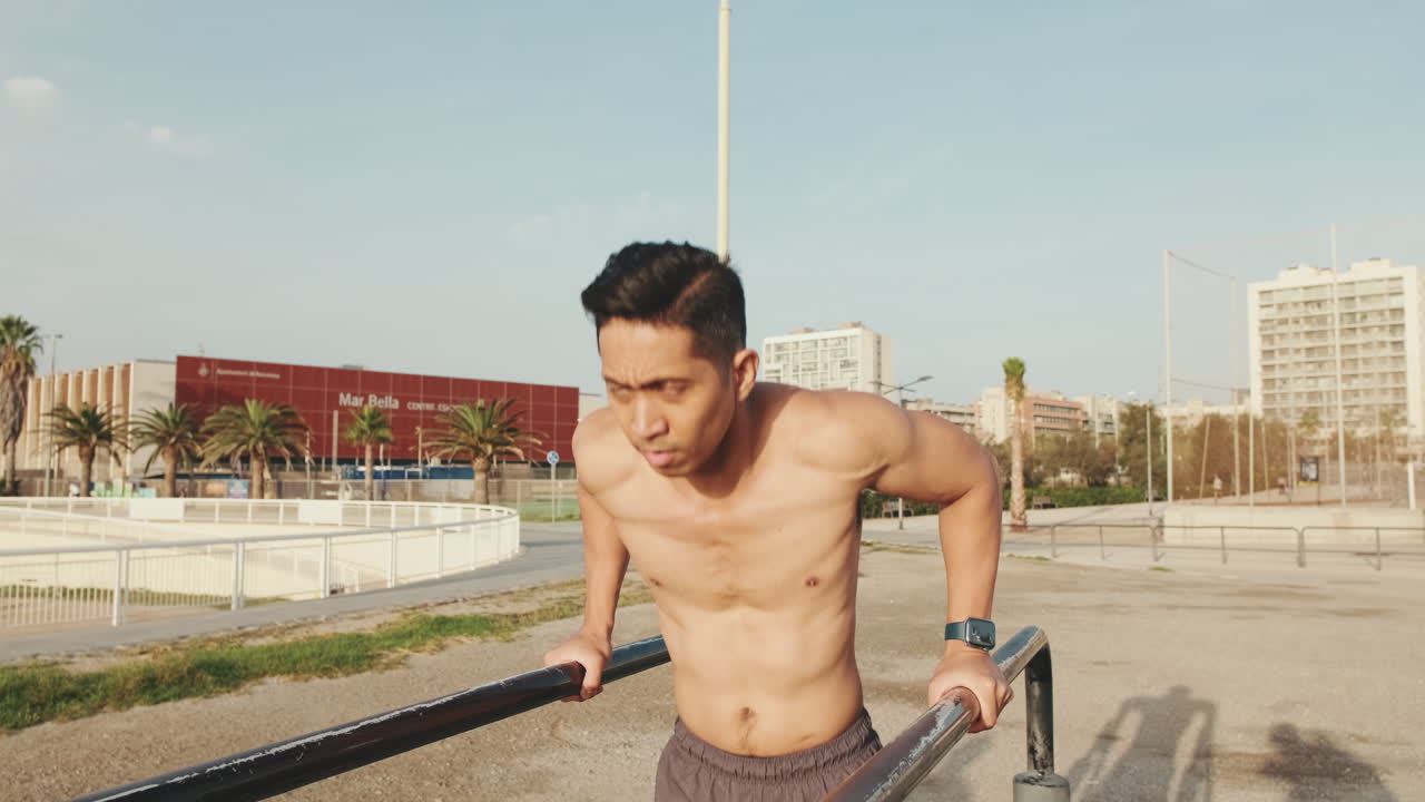 Man Exercising on Parallel Bars Outdoors