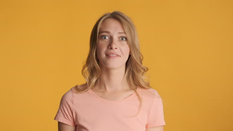 Caucasian woman celebrating victory on camera.