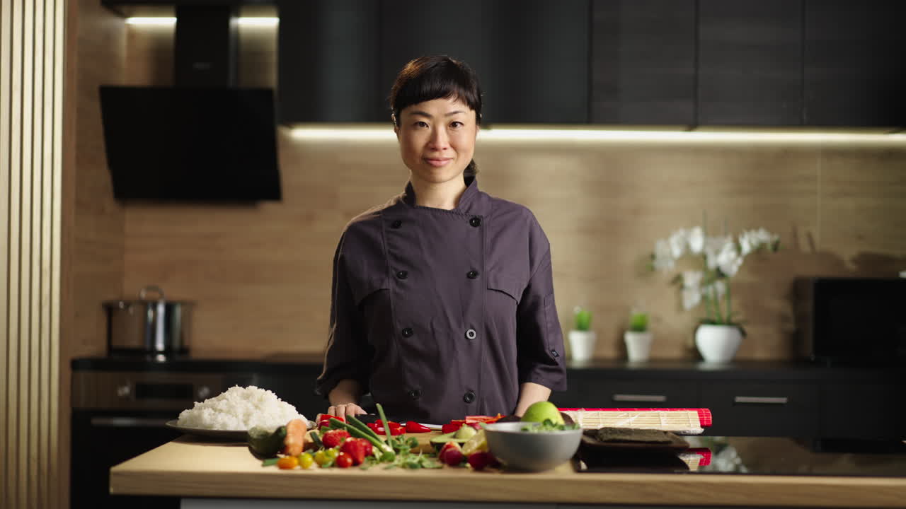 Asian woman chef preparing sushi in kitchen