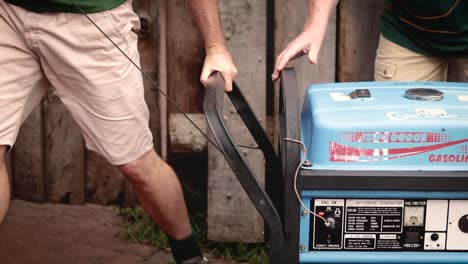 Two-determined-white-males-working-together-to-manually-start-a-gasoline-generator