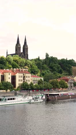 prague riverfront with church and boats