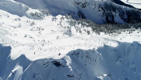 Skiers-standing-on-a-snow-capped-mountain-4k