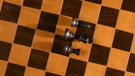 rook, bishop and king lay defeated after war on chessboard