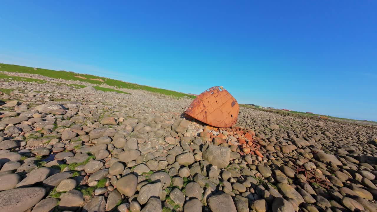Fast FPV drone orbit of a rusty shipwreck on Norway’s Rogaland coast. The decaying metal hull contrasts with the rugged landscape in this dynamic aerial maritime shot.