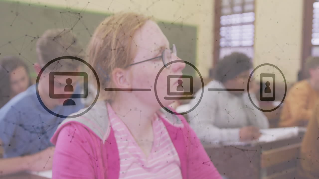 Teen girl focusing on classwork in classroom showing network overlay with screen and phone icons