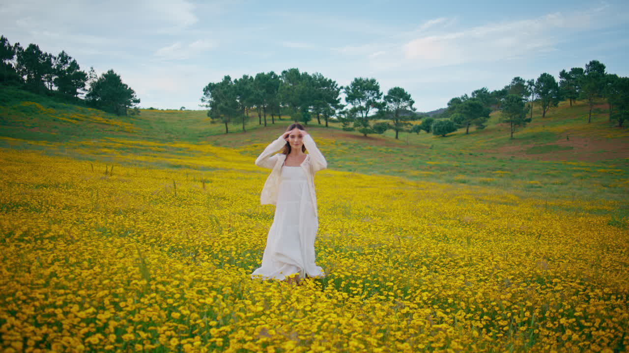 Joyful lady running flowers meadow enjoying nature back view. Happy girl walking