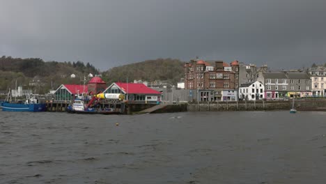 hand-held shot of a small ferry waiting to collect passengers in oban