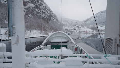 pov winter ferry boat ride in geirangerfjord to geiranger, norway, featuring snowy mountains and stunning fjord views