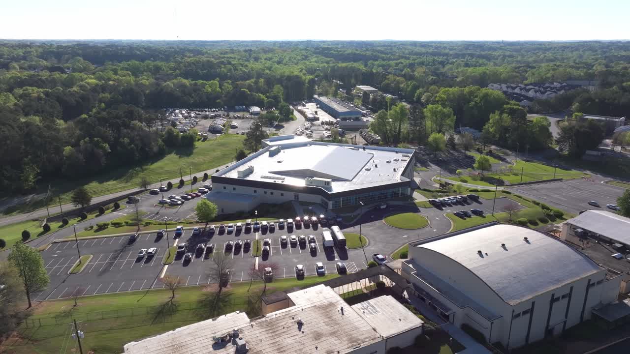 New Life Church in Decatur city, large parking area surrounded by green spaces, parks under a clear sky, Atlanta, Georgia, Aerial