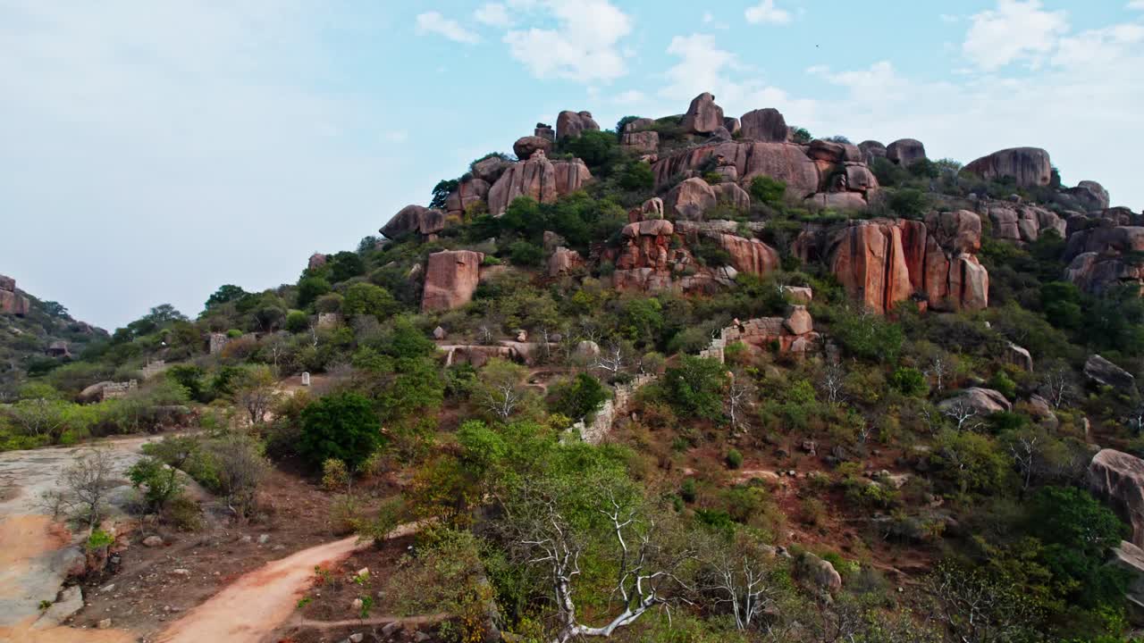 drone take off from ground towards sky in front of rock mountains at rachakonda fort, telangana, india. day time, drone shot, 4k.