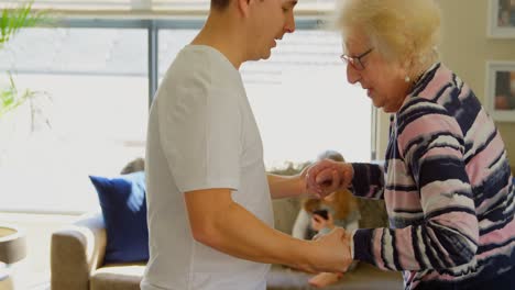 Mother-and-son-dancing-together-in-living-room-4k