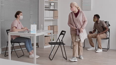 doctor receiving patients in line