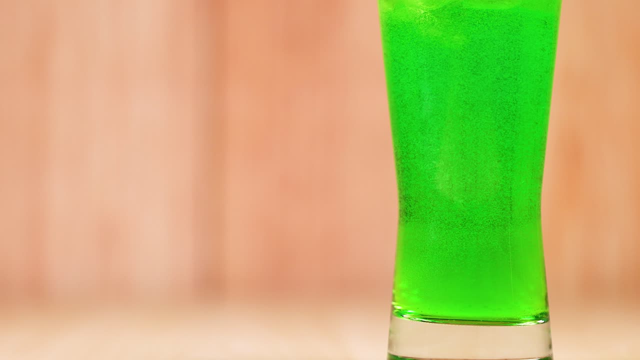 Bright green beverage in a clear glass