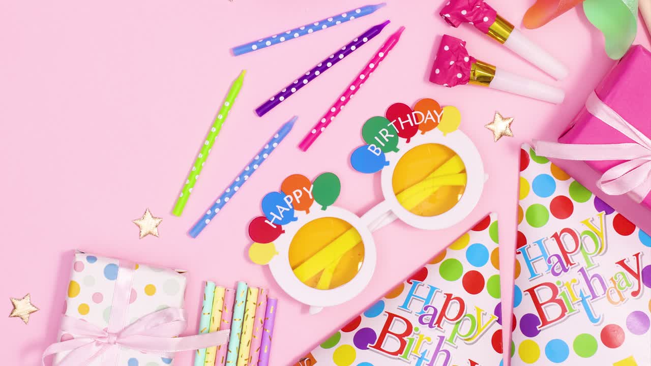 Party accessories and decorations on pastel pink theme. Stop motion