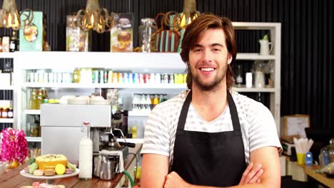 Male-waiter-standing-with-arms-crossed