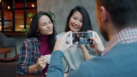 friends taking photo in a cafe