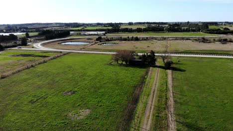 Aerial-view-of-a-horse-racing-track-in-the-countryside-on-a-sunny-day