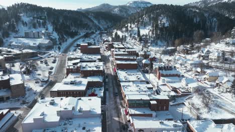 Drone-ascending-over-and-revealing-Deadwood,-South-Dakota-in-winter