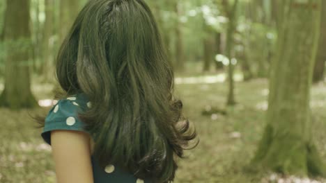 girl looking around in forest