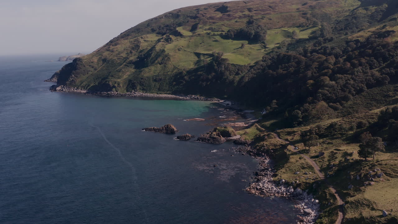 Coastal Scenery with Lush Hills and Rocky Shore