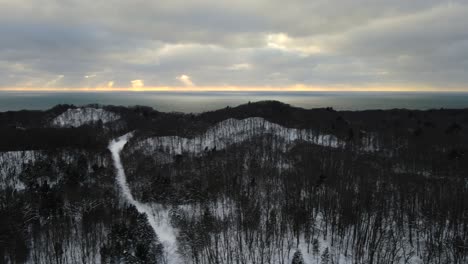 lake michigan winter. sun setting through dense clouds