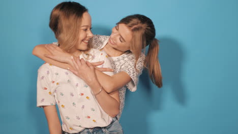 two happy women hugging