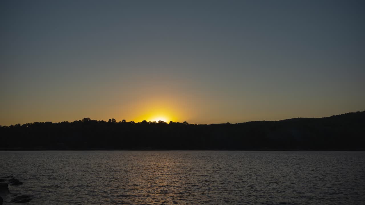 Sunset glistens over the hills surrounding Lake Jocassee in Salem, South Carolina